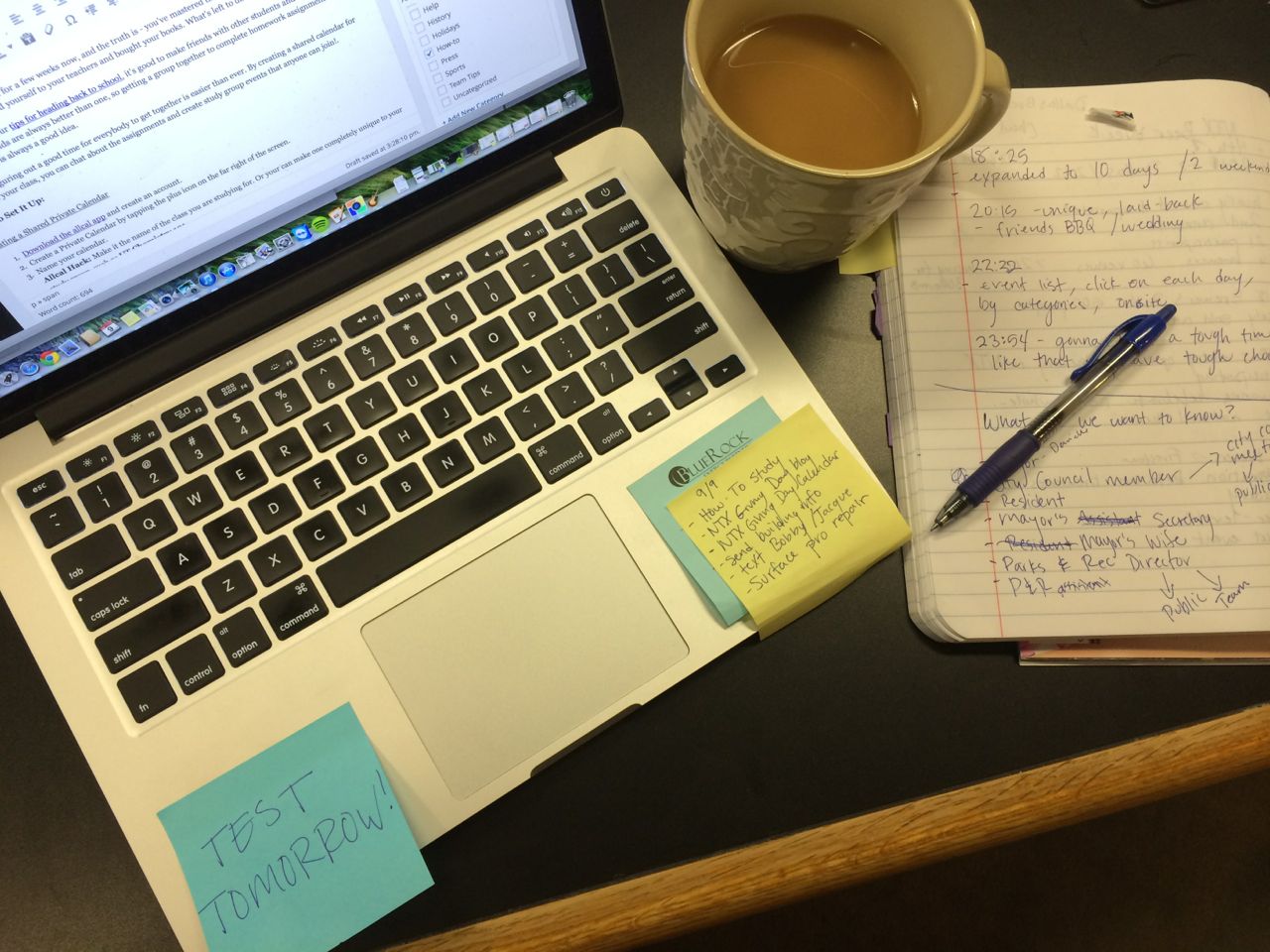 laptop post-its pen copybook and coffee